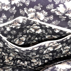Photo of the lining showing an opened zippered pocket.