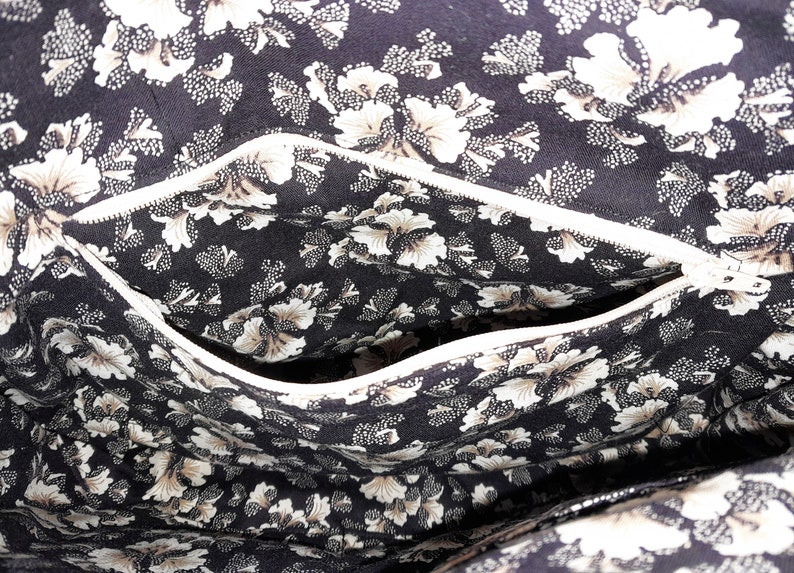 Photo of the lining showing an opened zippered pocket.