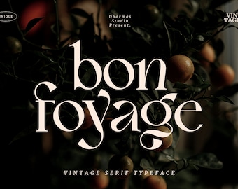 May include: A vintage serif typeface design with the text "bon voyage" in white against a dark background with green leaves and orange fruit.