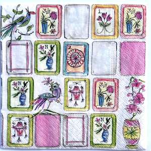 May include: White paper napkin with a repeating pattern of framed illustrations. The illustrations include flowers in vases, birds, and decorative lanterns in pink, blue, green, and yellow.