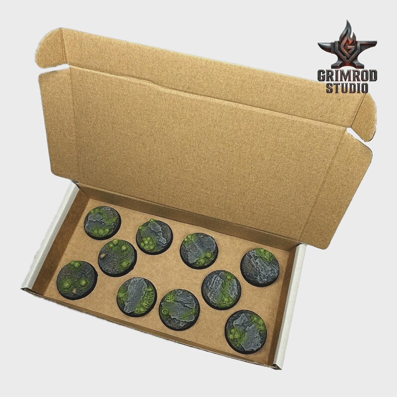 May include: A cardboard box containing ten miniature bases. The bases are round, with a gray stone and green moss design. The Grimrod Studio logo is visible in the upper right corner.