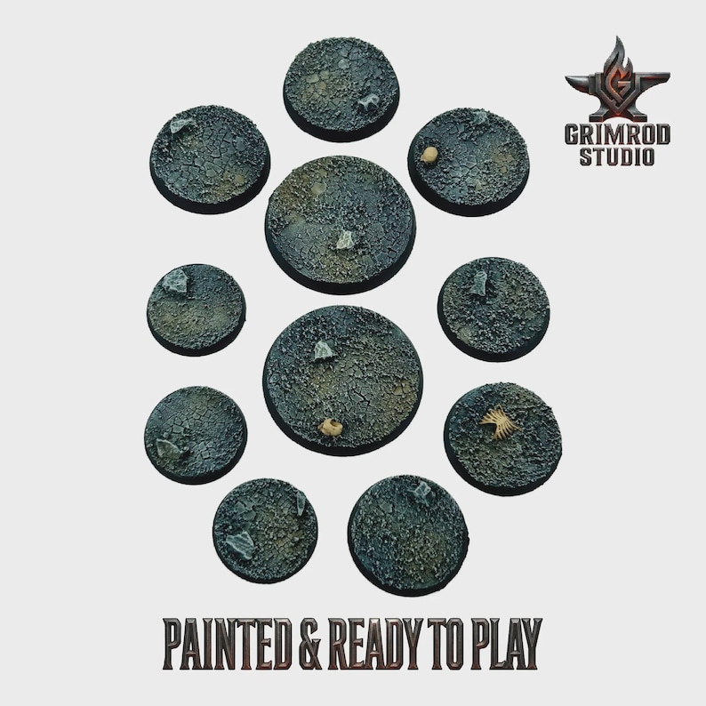 May include: A collection of eleven painted, round miniature bases with a textured, cracked earth appearance. The bases are various sizes and feature small rocks and debris. The text "PAINTED & READY TO PLAY" is at the bottom, with the Grimrod Studio logo in the upper right.