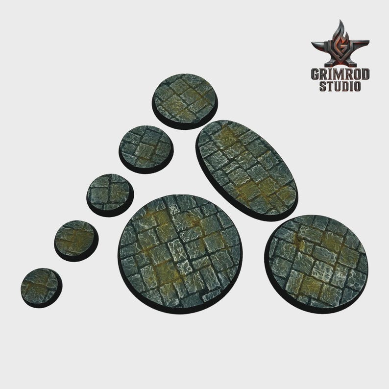 May include: A collection of gray stone bases in various shapes and sizes, including circles and an oval. The bases feature a cobblestone texture with yellow-green accents. The Grimrod Studio logo is in the upper right corner.
