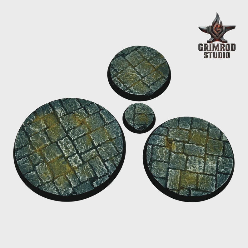 May include: Four circular, stone-textured bases in varying sizes. The bases feature a cobblestone pattern in shades of gray and green, with yellow highlights. The Grimrod Studio logo is in the upper right corner.