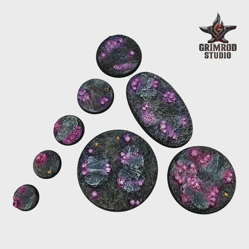 May include: A collection of textured, circular and oval bases for miniature figures. The bases are dark gray with purple and pink organic-looking details. The Grimrod Studio logo is in the upper right corner.