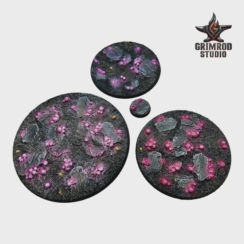 May include: A set of four circular bases with a textured, dark gray surface. The bases feature pink, purple, and gray organic-looking elements. The Grimrod Studio logo is in the upper right corner.
