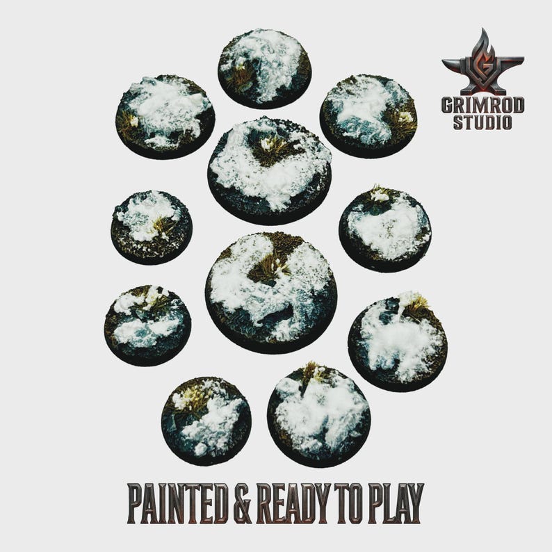 May include: A collection of eleven circular, miniature bases, painted with a snow-covered terrain effect. The bases vary in size and are arranged in a circular pattern. The text "PAINTED & READY TO PLAY" is at the bottom.