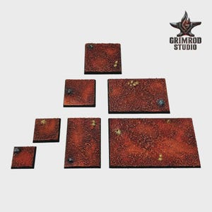 May include: A collection of textured, reddish-brown terrain tiles in various rectangular and square shapes. The tiles have a rough, speckled surface with small, irregular details. The Grimrod Studio logo is visible in the upper right corner.