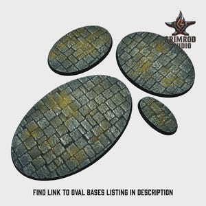 May include: Four oval-shaped bases with a cobblestone texture, in varying sizes. The bases are primarily gray with yellow and brown accents, suggesting an aged appearance. The Grimrod Studio logo is in the top right corner. Text at the bottom reads: FIND LINK TO OVAL BASES LISTING IN DESCRIPTION.