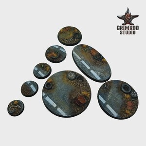 May include: A collection of miniature terrain bases with a post-apocalyptic theme. The bases are various shapes and sizes, featuring asphalt roads, debris, and tire details. The color palette includes browns, grays, and rust tones, with a white road stripe.