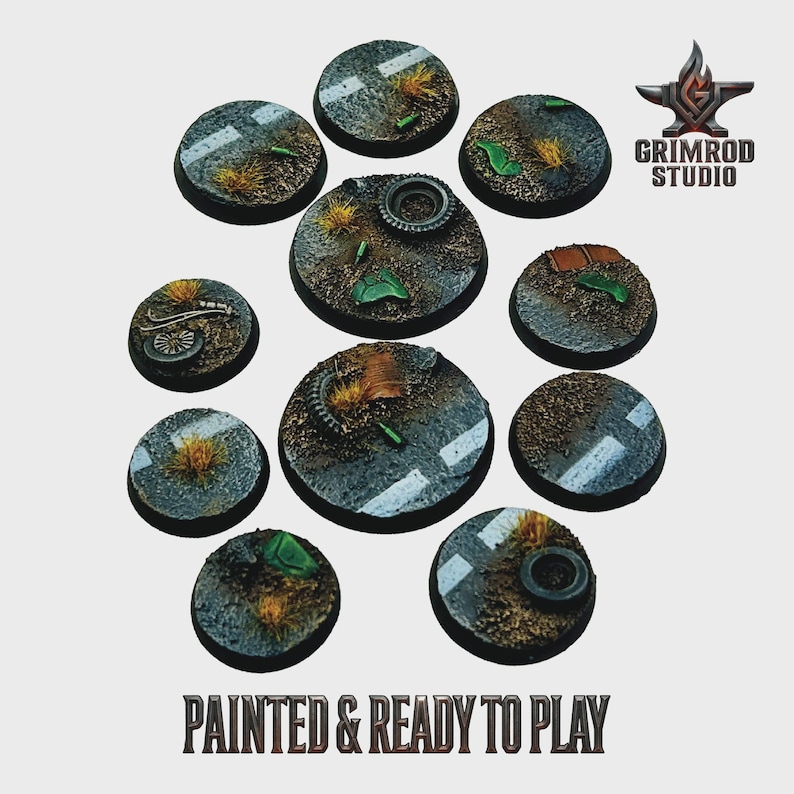 May include: A collection of painted miniature bases, each circular with a road and terrain design. The bases feature asphalt, grass, and debris, with some including tires and mechanical parts. The text "PAINTED & READY TO PLAY" is visible.