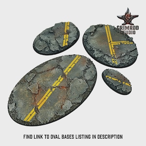 May include: Four oval-shaped miniature bases with a cracked asphalt design. Each base features yellow road markings, simulating a section of a road. The bases are designed for miniature figures and tabletop gaming.