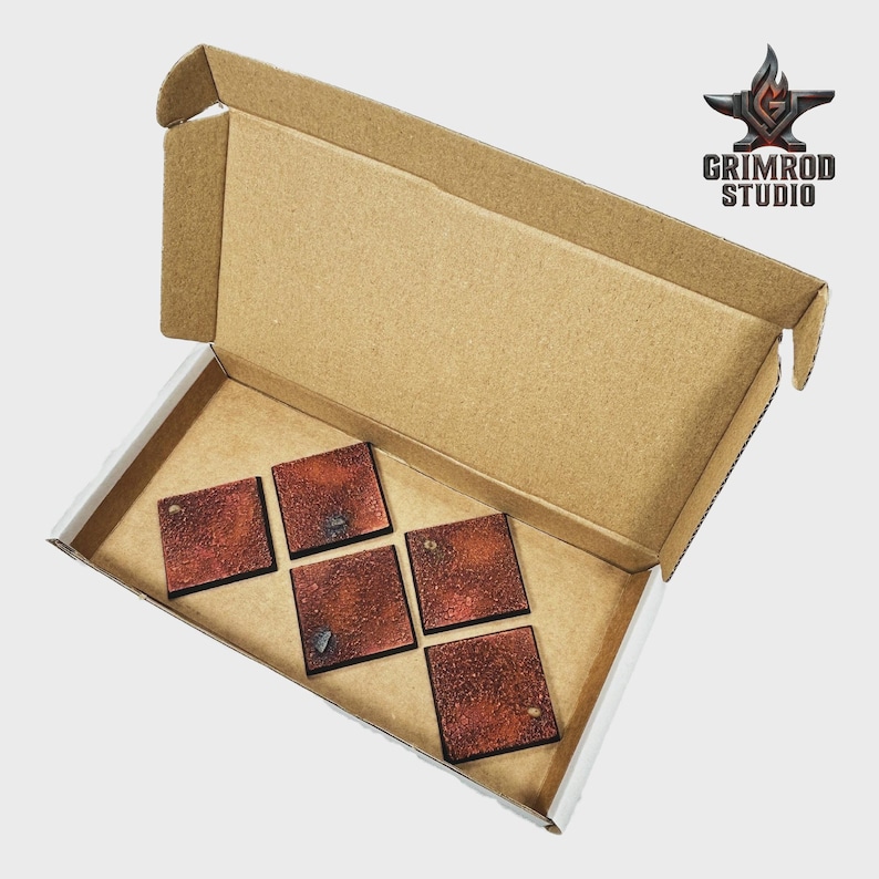 May include: A cardboard box with an open lid, revealing five square, textured, reddish-brown tiles. The tiles have dark edges and small details. The Grimrod Studio logo is in the upper right corner.