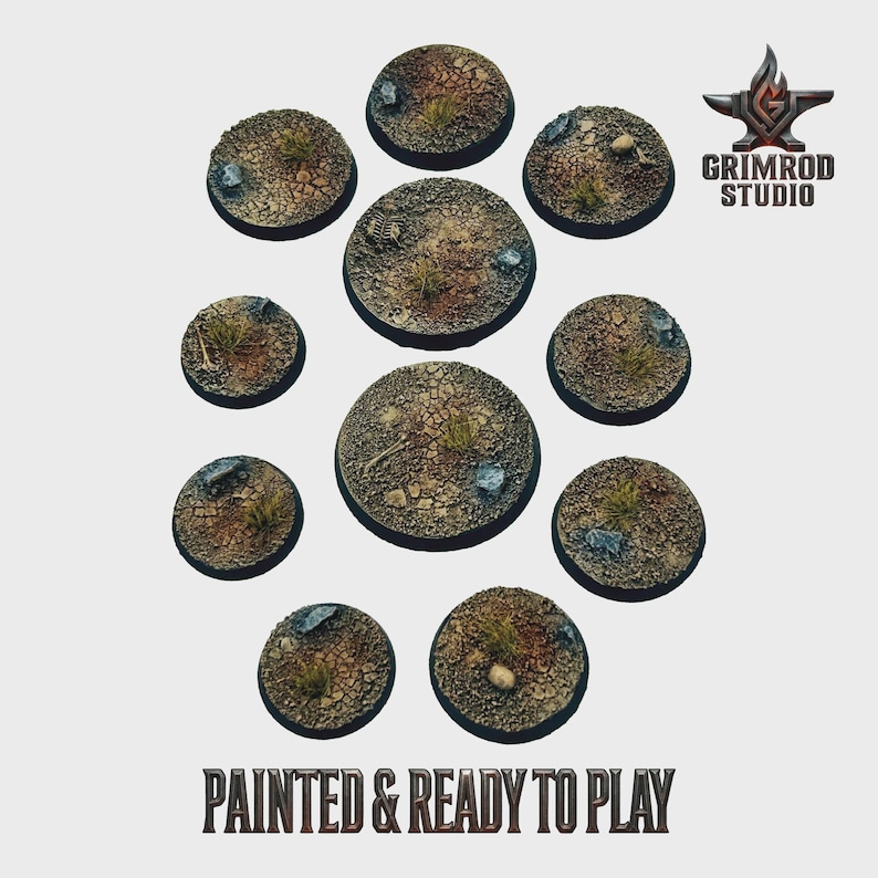 May include: A collection of ten circular, textured bases for miniature figures. The bases are painted with a desert-like terrain, featuring cracked earth, small rocks, and patches of dry grass. The text "PAINTED & READY TO PLAY" is visible.