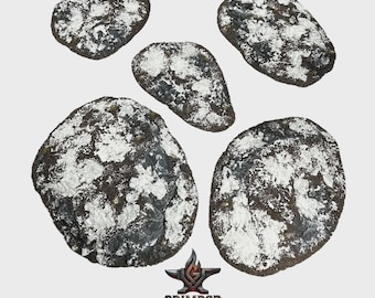 May include: Five irregularly shaped, dark gray terrain pieces with white accents, resembling snow or frost. The pieces vary in size and are arranged against a light background. The Grimrod Studio logo is visible at the bottom.