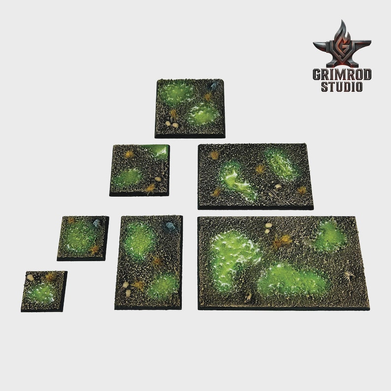 May include: A collection of miniature terrain pieces, featuring various sizes of square and rectangular bases. The bases are painted with a dark, earthy tone, accented by patches of vibrant green and small, detailed elements.