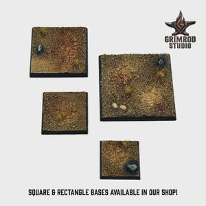 May include: Four square and rectangular bases with textured, desert-like surfaces. The bases are various sizes, with a mix of tan, brown, and green tones, and small rock and grass details. The text "SQUARE & RECTANGLE BASES AVAILABLE IN OUR SHOP!" is at the bottom.