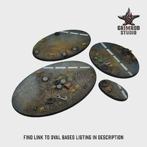 May include: Four oval-shaped miniature bases with a road design, featuring white dashed lines and scattered debris like tires and trash. The bases are in varying sizes and are designed for tabletop gaming. The Grimrod Studio logo is in the upper right corner. Text at the bottom reads: FIND LINK TO OVAL BASES LISTING IN DESCRIPTION.