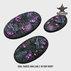 May include: Three oval bases with a textured, dark surface and vibrant purple and gray accents. The bases feature a detailed, otherworldly design, with the text "OVAL BASES AVAILABLE IN OUR SHOP!" at the bottom and the Grimrod logo in the top right corner.