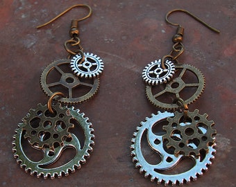May include: A pair of silver and bronze steampunk earrings with multiple gear-shaped charms.