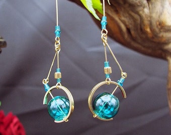Individually: light steampunk style sextant blue blown glass earring