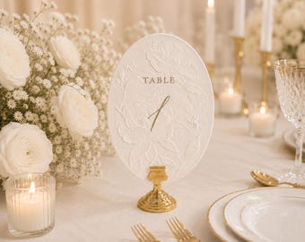 Oval Wedding Table Number with Floral 3D Blind Embossing on European cotton paper in two colors – Elegant Wedding Table Décor