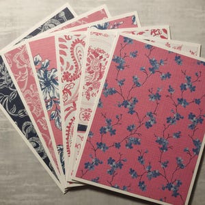 May include: A set of six patterned cards with a pink and blue floral design. The cards are all different patterns, but they all have a similar color scheme.