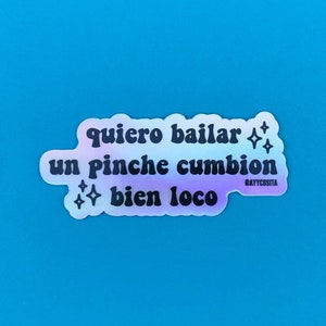 May include: A holographic sticker with the text "quiero bailar un pinche cumbion bien loco" and the social media handle "@ayycosita" in smaller text.