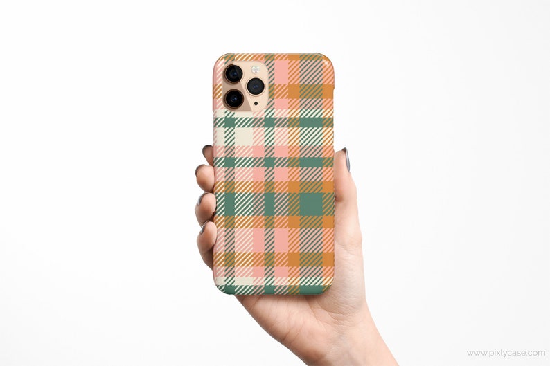 May include: A phone case with a plaid pattern in shades of pink, green, and orange.
