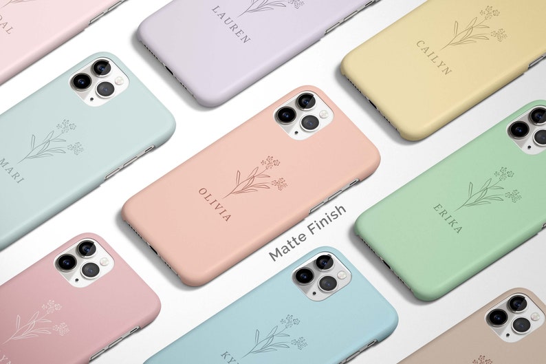 May include: A collection of phone cases with a floral design and personalized names. The cases are available in a variety of colors, including pink, blue, green, and yellow. The text "Matte Finish" is printed on one of the cases.