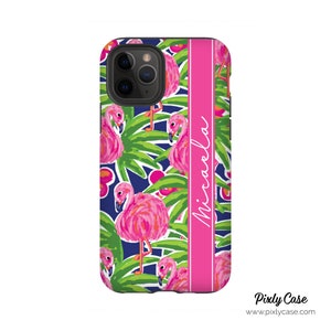 May include: A pink and blue phone case with a flamingo pattern and the name "Michaela" printed on the side.