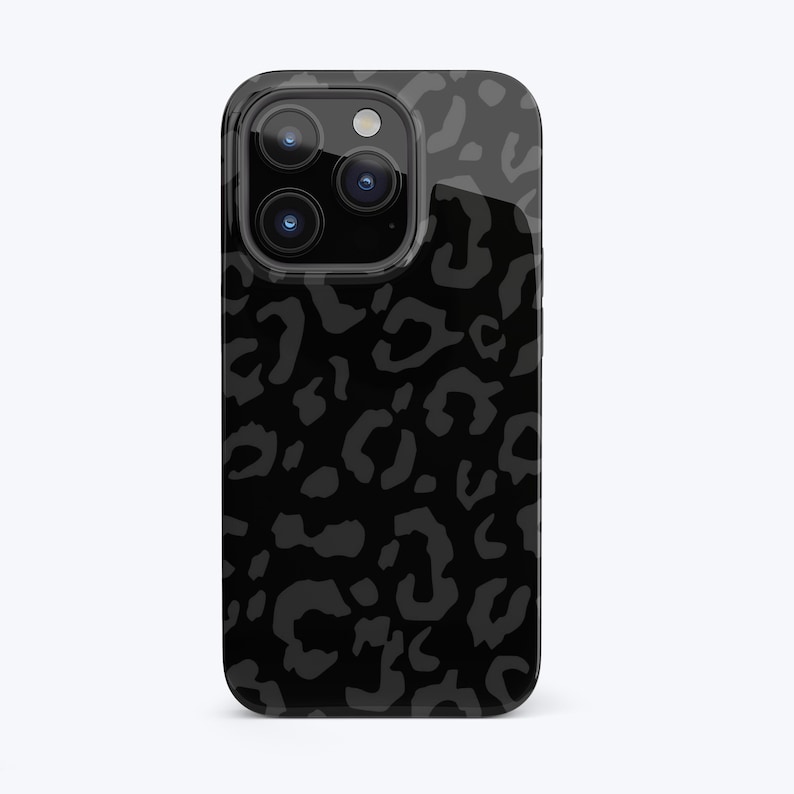 May include: Black phone case with a leopard print design. The case has a raised camera bump and a glossy finish.