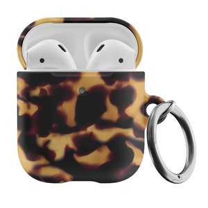May include: A tortoiseshell patterned silicone case for AirPods with a silver metal keychain ring.