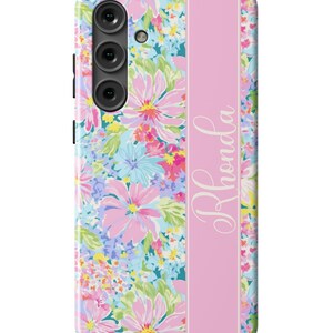 May include: A pink floral phone case with a pink stripe down the center and the name "Rhonda" written in white script.