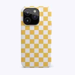 May include: A yellow and white checkered phone case for an iPhone.