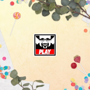 PLAY sticker with picture of Eric M. Lang (board game designer)