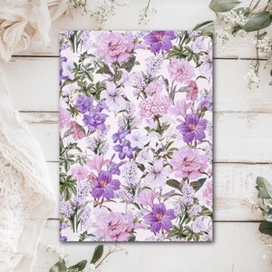 May include: A rectangular floral print featuring a variety of flowers in shades of purple, pink, and white. The flowers include peonies, clematis, and lilies, set against a light background. The design is detailed and vibrant, with green leaves.