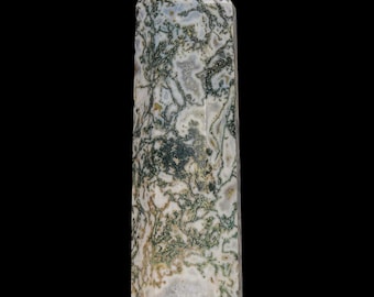 May include: A polished stone tower with a hexagonal base and a pointed top. The surface features a white and translucent base color with intricate, moss-like green and dark brown dendritic inclusions throughout the entire structure.
