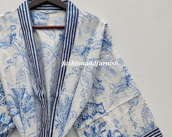 May include: A white cotton robe with a blue and white striped trim and a blue and white jungle print featuring leaves, birds, and a leopard. The robe has a tie belt.