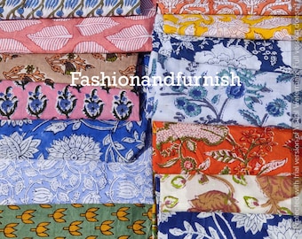 May include: A stack of colorful fabric squares with various floral and geometric patterns. The fabrics are all cotton and are perfect for quilting, sewing, or crafting.