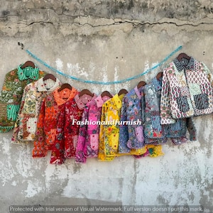 May include: A collection of ten quilted jackets hanging in a row, each featuring distinct floral and geometric block-print patterns in vibrant colors including green, orange, red, pink, yellow, blue, and white, with the text Fashionandfurnish.