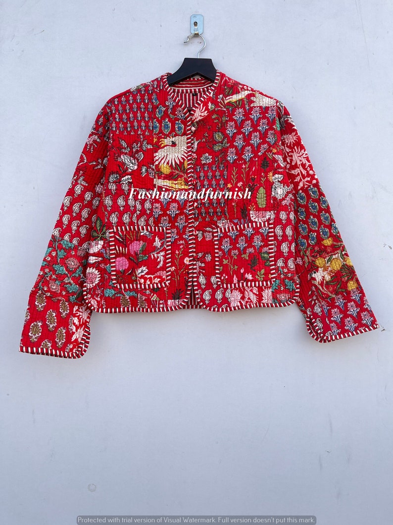 May include: A red quilted jacket with a floral print and white trim. The jacket has a mandarin collar and a button closure. The text "Fashionandfurnish" is visible on the front of the jacket.