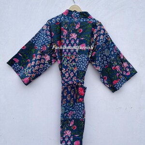 May include: A blue floral print robe with a matching belt hangs on a hanger. The robe features a patchwork design with pink and green floral patterns. The text "Fashionandfurnish" is visible on the robe.