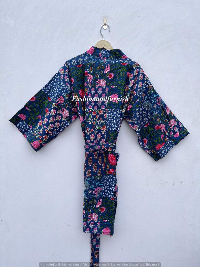May include: A blue floral print robe with a matching belt hangs on a hanger. The robe features a patchwork design with pink and green floral patterns. The text "Fashionandfurnish" is visible on the robe.