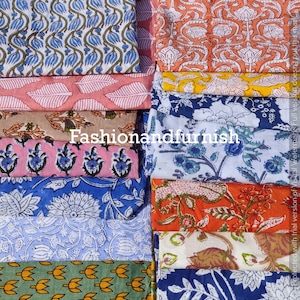 May include: A collection of folded fabric pieces with various floral and leaf patterns in shades of red, blue, orange, pink, and yellow. The text "fashionandfurnish" is visible. The fabrics are likely for home decor or crafting.