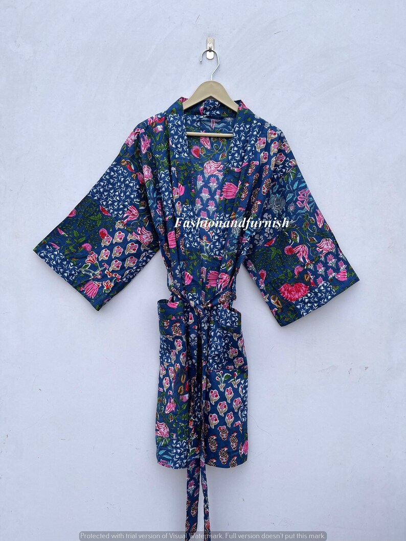 May include: A navy blue robe with a floral pattern in pink and green. The robe is hanging on a wooden hanger. The text "Fashionandfurnish" is visible on the robe.
