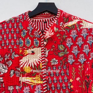 May include: Red quilted jacket with a floral print and a mandarin collar. The jacket has a striped lining and a button closure. The text "Fashionandfurnish" is visible on the jacket.