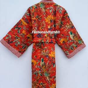 May include: A quilted red robe featuring a floral and bird design. The robe has a matching belt and red and white striped trim on the sleeves. The text "Fashionandfurnish" is visible on the robe.