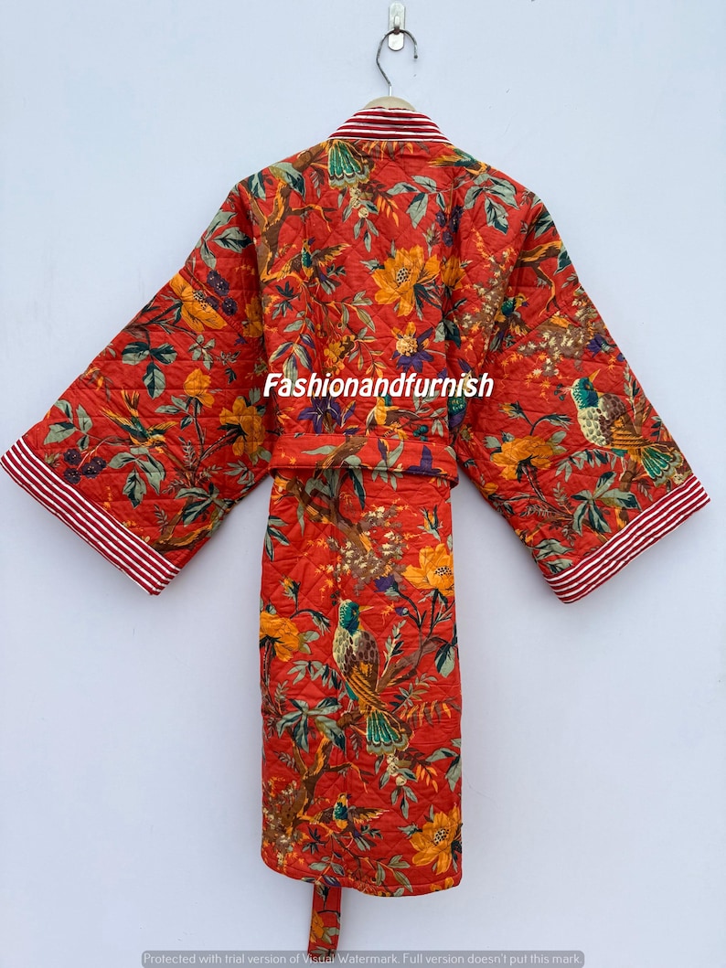 May include: A quilted red robe featuring a floral and bird design. The robe has a matching belt and red and white striped trim on the sleeves. The text "Fashionandfurnish" is visible on the robe.