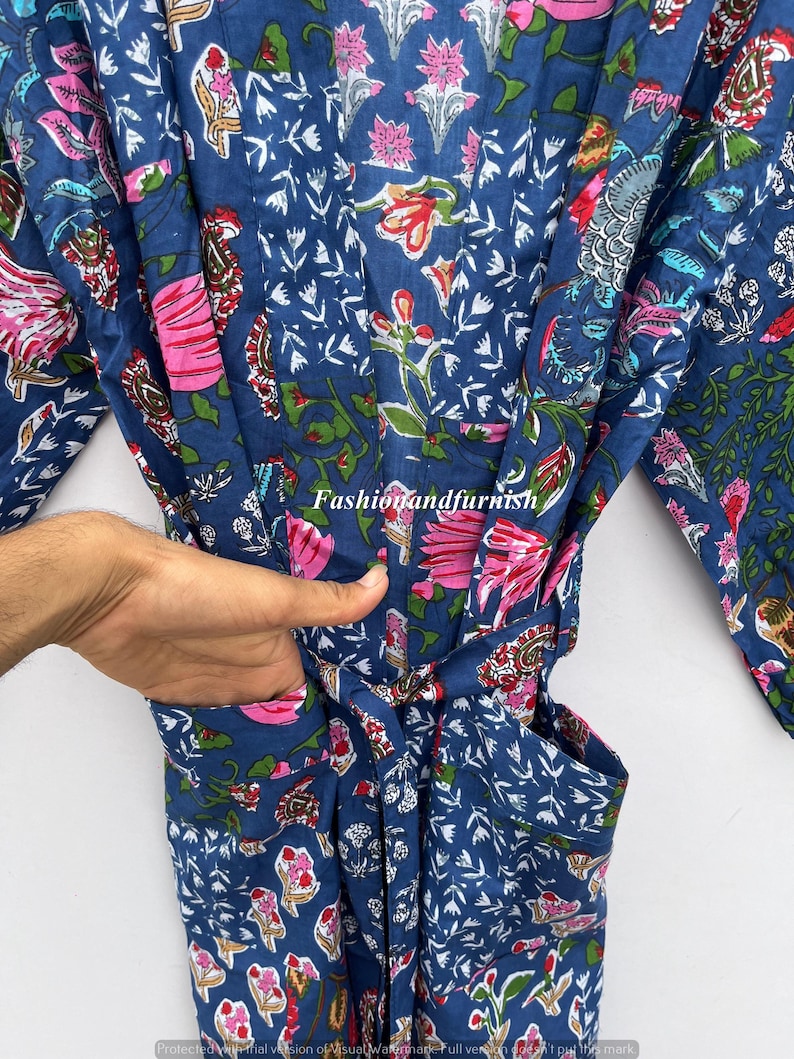May include: A blue floral patterned robe with pink and red flowers and green leaves. The robe has a belt and pockets. The text "Fashionandfurnish" is visible on the robe.